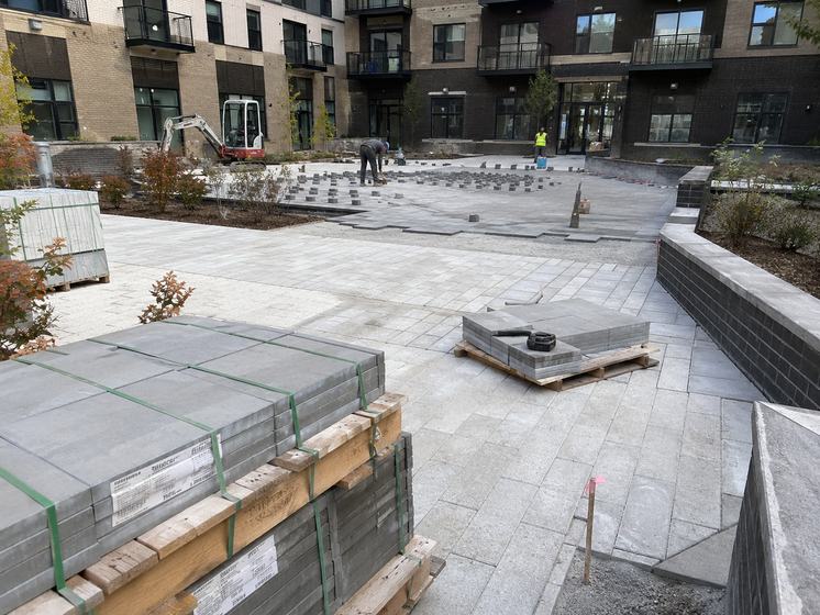 Pavers being installed in a multifamily courtyard