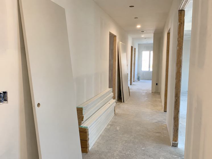 Interior doors and trim staged in a corridor
